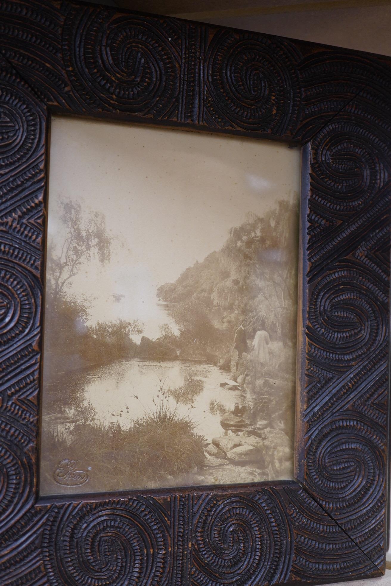 A pair of Maori carved wood photograph frames containing contemporary New Zealand photographs c.1900-10, carved in relief with rauponga lines and spirals, inset with contemporary albumen photos, depicting figures by Waik